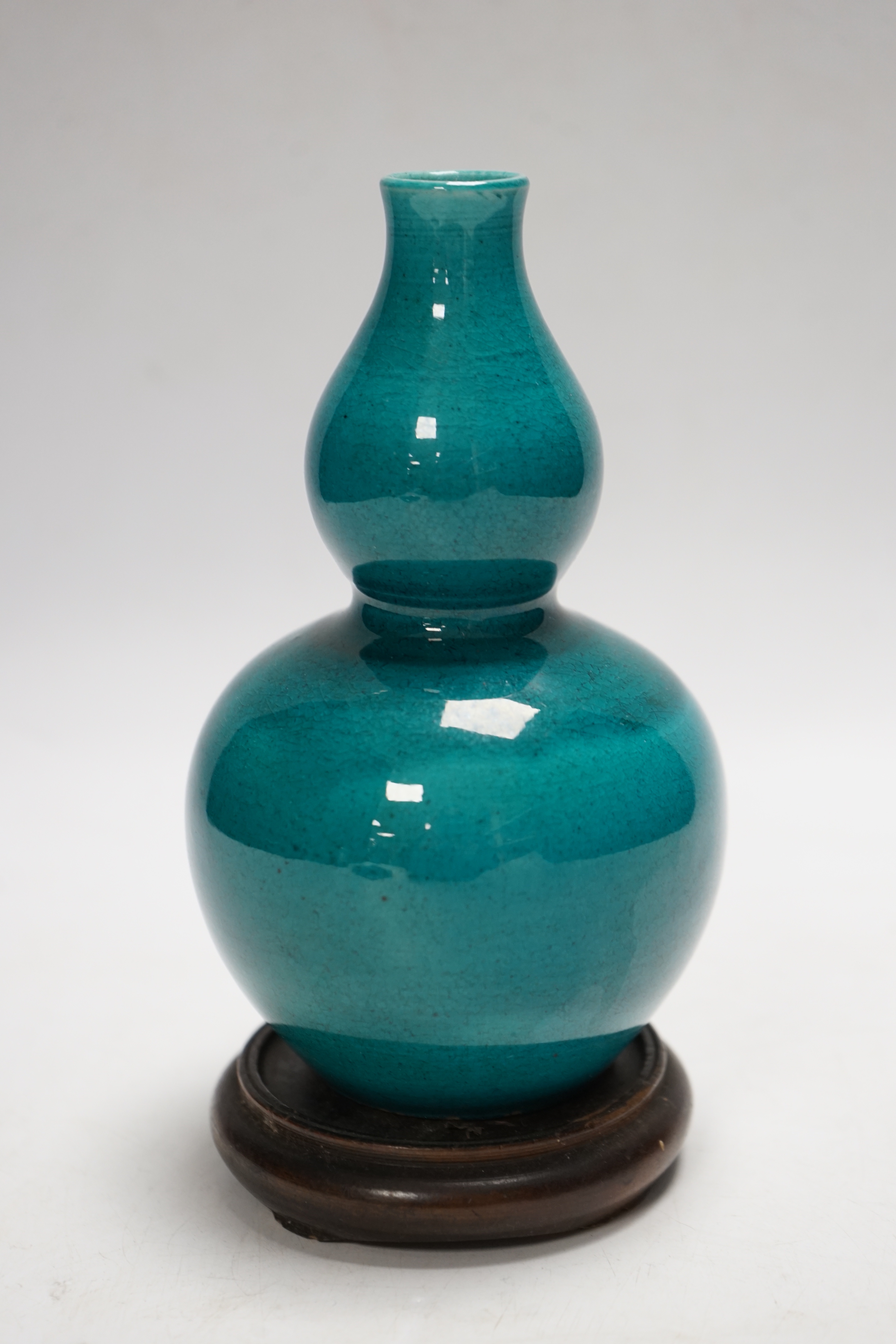A Chinese turquoise glazed double gourd vase, on stand, 17cm